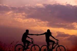 Couple riding bikes on a trip as an anniversary gift