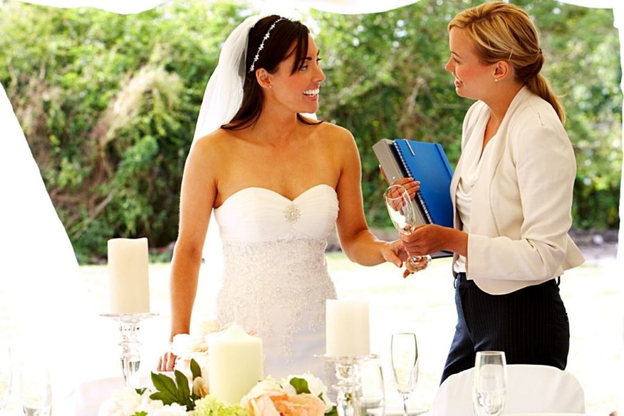 event planner and bride at her wedding discussing the planning